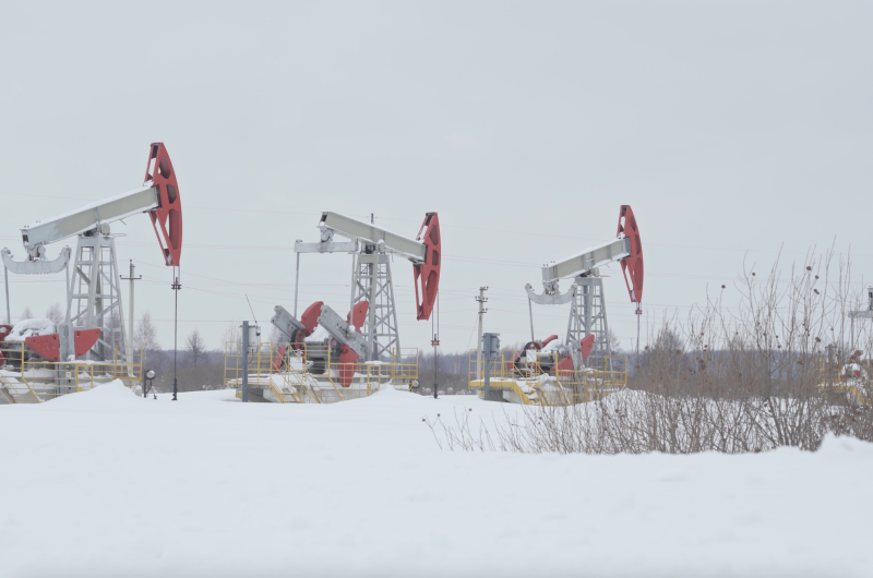 Russian pumpjacks in a winter field.